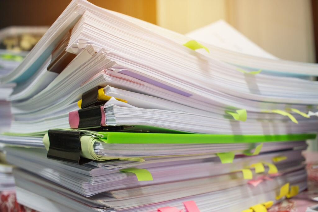 stacks of computer paper clipped together by bulldog clips