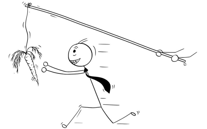 Cartoon stick man drawing conceptual illustration of businessman pursue or chase after carrot illusion or delusion of money. Business concept of greed.