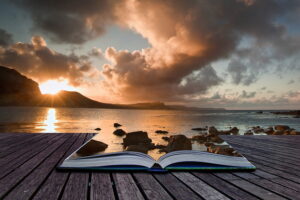 Creative composite image of seascape in pages of magic book