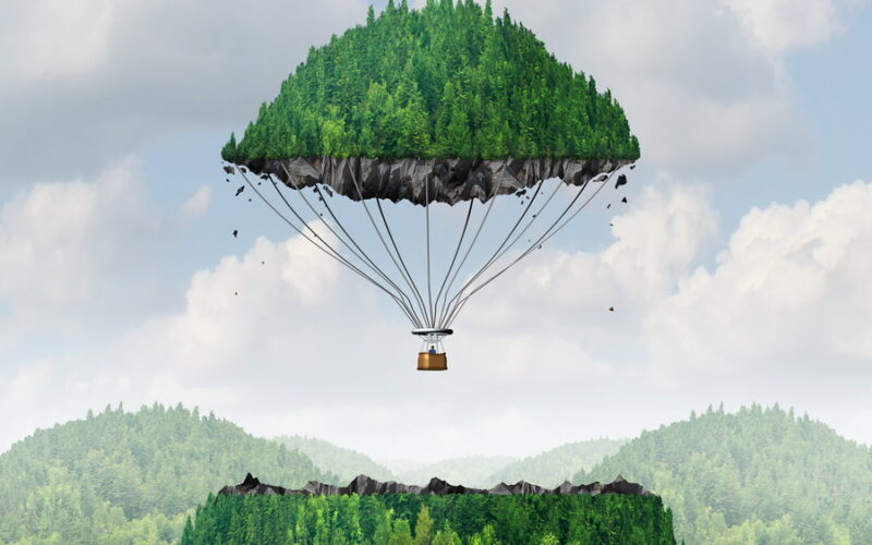 Imagination concept as a person lifting off with a detached top of a mountain floating up to the sky as a hot air balloon as a metaphor for the power of imagining traveling and dreaming of moving mountains.