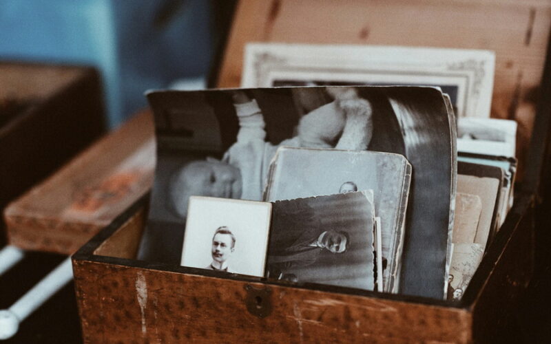 Old back and white photos in a small wooden box